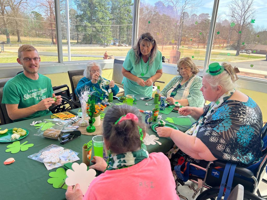 A group of residents avoiding the impact of social isolation on seniors with craft activities at Nightingale